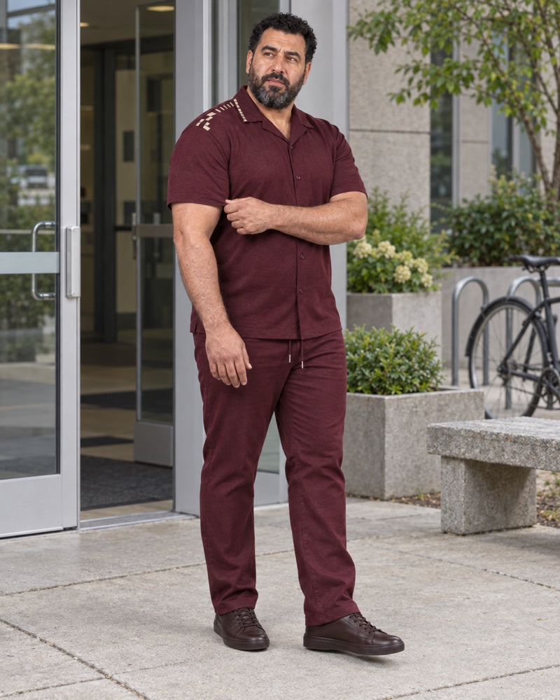 Burgundy Oat Margin Cut outfit worn at an ordinary civic-office courtyard with concrete benches, bike rack, planter boxes and a standard glass doorway