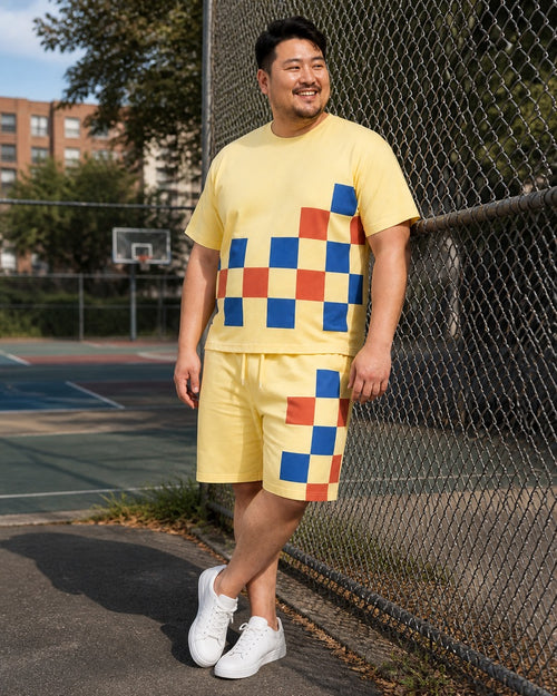 Big and tall man styling the Butter Cobalt Checker Relay t-shirt and matching shorts set in a natural lifestyle scene