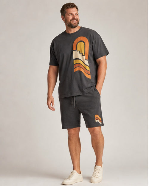 Big and tall man wearing the Canyon Sun Relay t-shirt and matching shorts set, clean full-body studio view