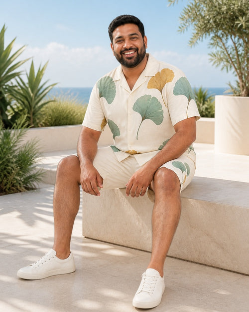 Big and tall man styling the Celadon Ginkgo Scatter pocket-free shirt and matching shorts set in a lifestyle scene