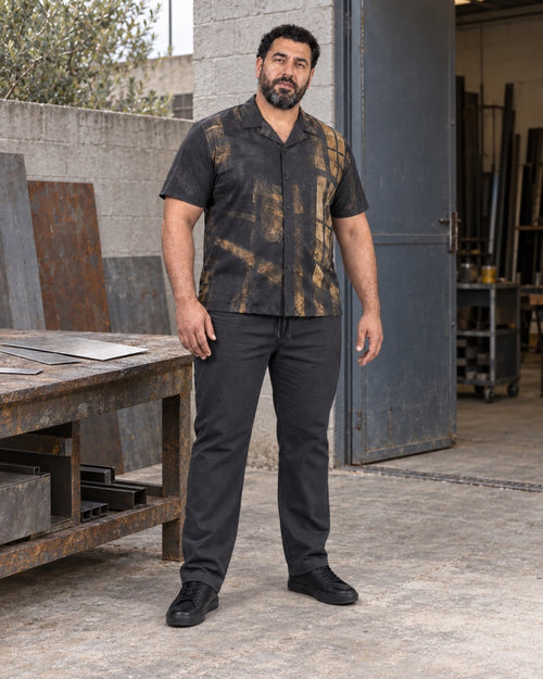 Charcoal Brass Foundry Window outfit worn at an ordinary small metalworking-studio courtyard with a plain workbench, sheet-metal offcuts, standard doorway and concrete floor