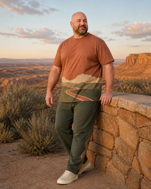 Big and tall man styling the Clay Switchback Range t-shirt and matching pants set in a lifestyle scene