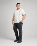 Big and tall man wearing the Cloudline Frame off-white polo and graphite pants set, front three-quarter view