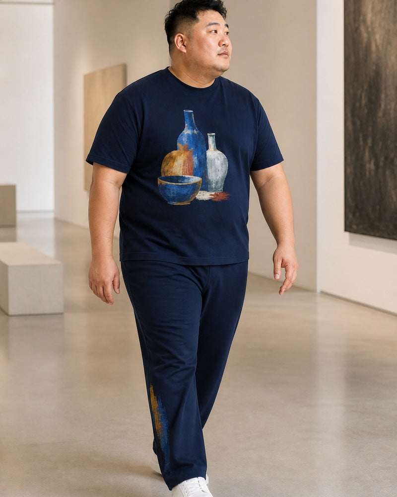 Big and tall man styling the Cobalt Vessel Study t-shirt and matching pants set in a natural lifestyle scene