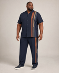 Big and tall man wearing the Copper Ledger short-sleeve shirt and matching pants set, full-body front three-quarter studio view
