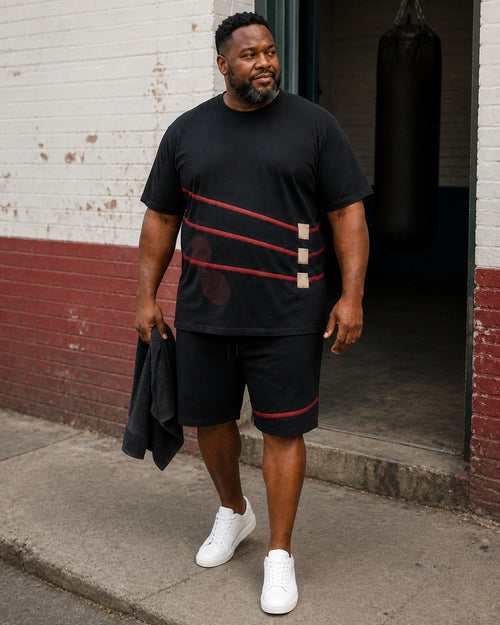 Big and tall man styling the Crimson Corner Rope t-shirt and matching shorts set in a lifestyle scene