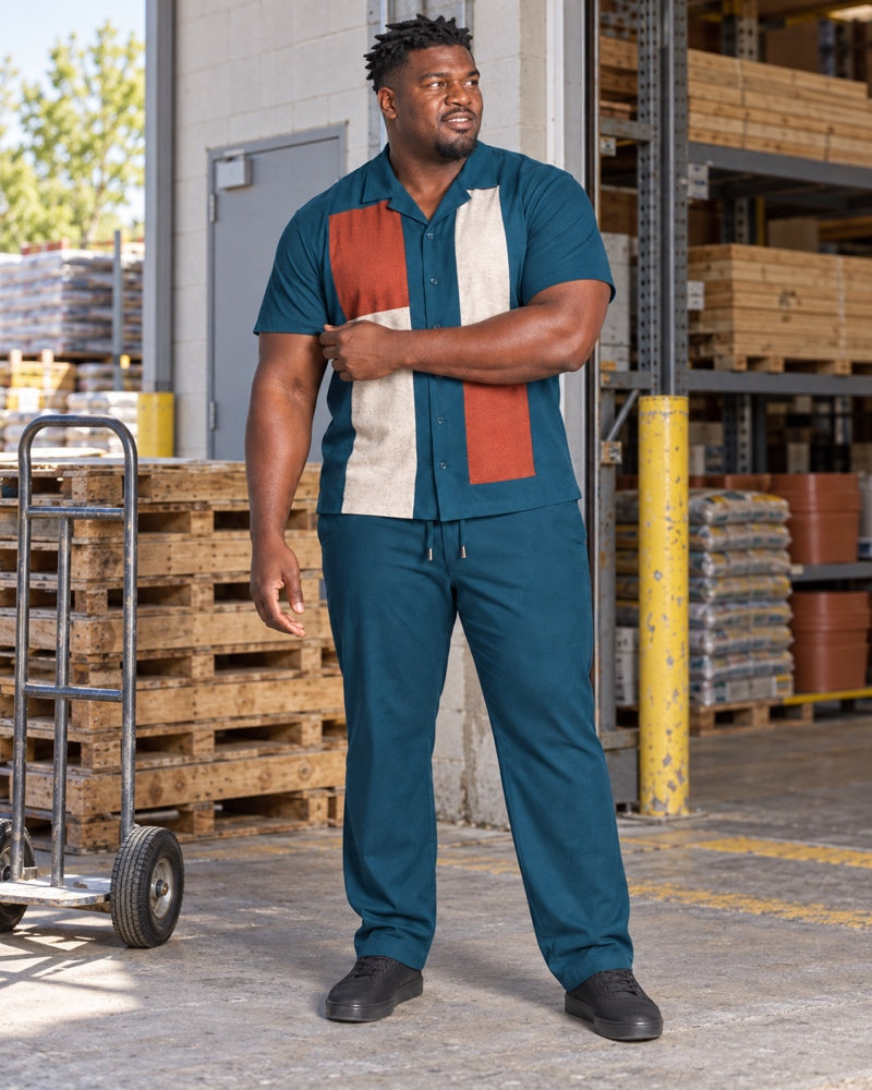 Deep Teal Rust Switchyard Blocks outfit worn at an ordinary neighborhood hardware loading bay with wood pallets, a plain hand truck, steel shelving and standard service door