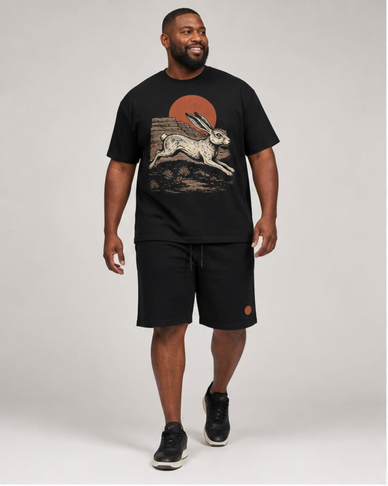 Big and tall man wearing the Dust Mesa Jackrabbit t-shirt and matching shorts set, clean full-body studio view