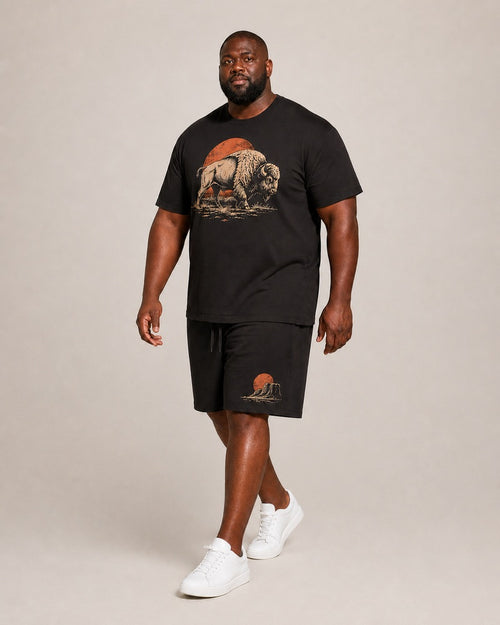 Big and tall man wearing the Dustland Bison T-shirt and matching shorts set, clean full-body studio view