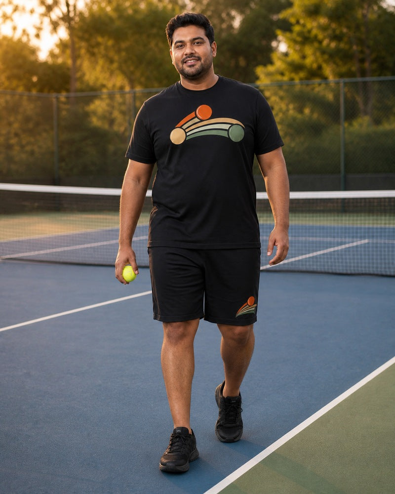 Big and tall man styling the Ember Match Point Arc t-shirt and matching shorts set in a natural lifestyle scene