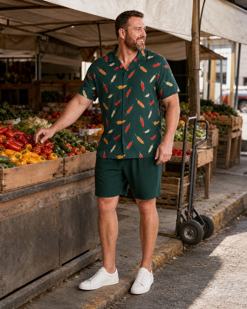 Big and tall man styling the Forest Saffron Pepper Market pocket-free shirt and matching shorts set in a natural lifestyle scene