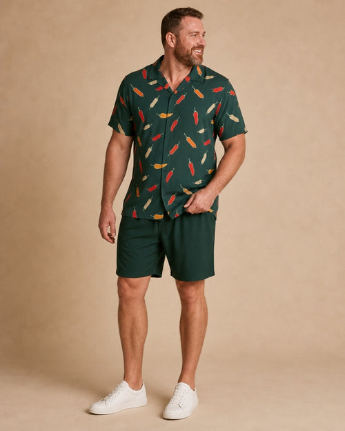 Big and tall man wearing the Forest Saffron Pepper Market pocket-free shirt and matching shorts set, full-body product view