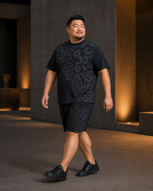 Big and tall man styling the Graphite Leopard Veil t-shirt and matching shorts set in a lifestyle scene