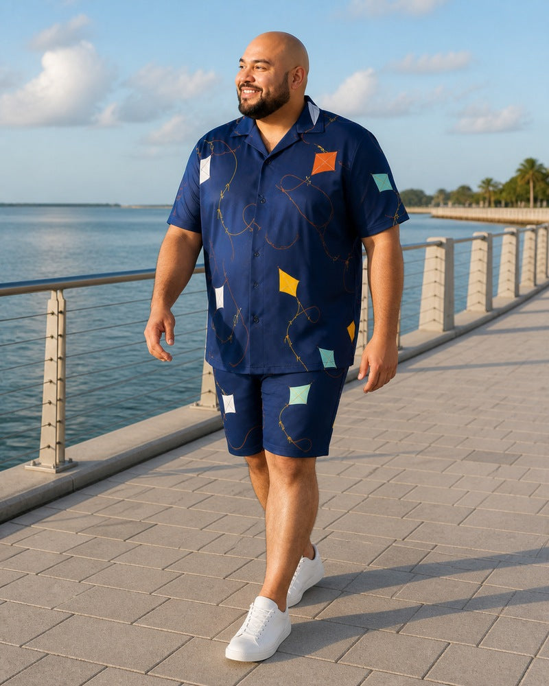 Big and tall man styling the Harbor Kite Cutout pocket-free shirt and matching shorts set in a natural lifestyle scene