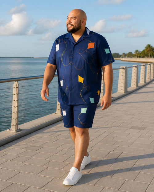 Big and tall man styling the Harbor Kite Cutout pocket-free shirt and matching shorts set in a natural lifestyle scene