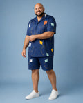 Big and tall man wearing the Harbor Kite Cutout pocket-free shirt and matching shorts set, full-body product view