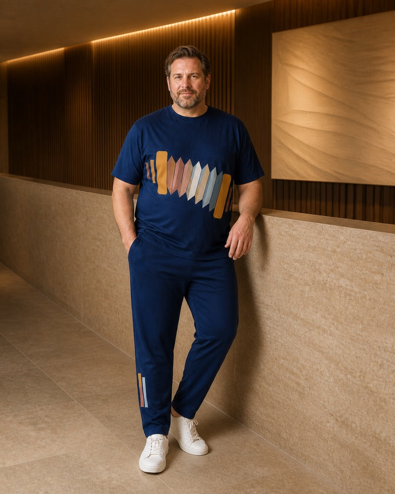 Big and tall man styling the Indigo Accordion Signal t-shirt and matching pants set in a natural lifestyle scene
