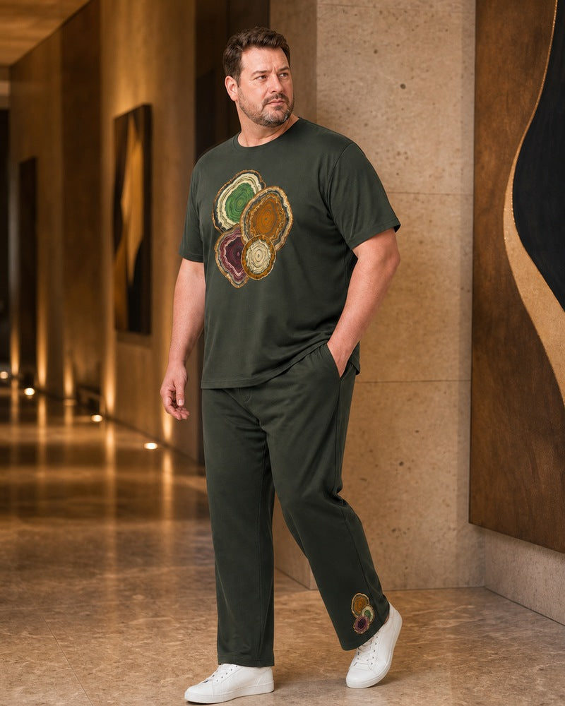Big and tall man styling the Moss Mineral Window t-shirt and matching pants set in a natural lifestyle scene