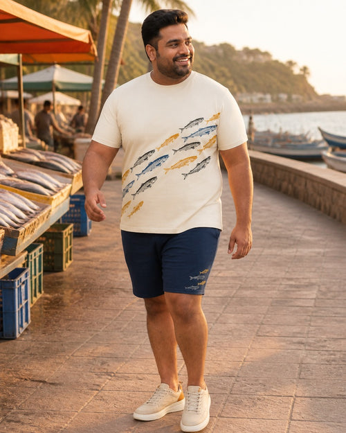 Big and tall man styling the Ochre Sardine Parade t-shirt and matching shorts set in a lifestyle scene