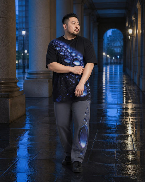 Big and tall man styling the Onyx Rain Lens t-shirt and matching pants set in a lifestyle scene