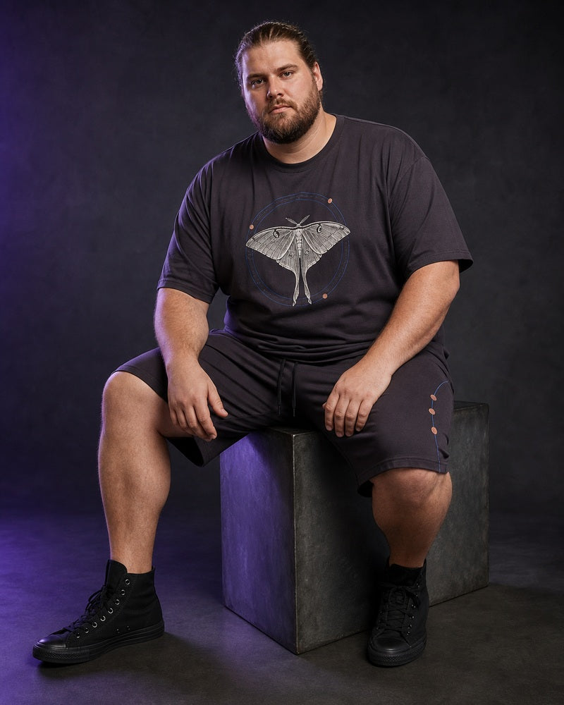 Big and tall man wearing the Orbit Moth Atlas matching set in an evening urban setting