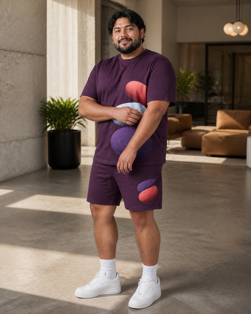 Big and tall man styling the Plum Bubble Shadow t-shirt and matching shorts set in a lifestyle scene