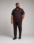 Big and tall man wearing the Plum Circuit short-sleeve shirt and matching pants set, front three-quarter view