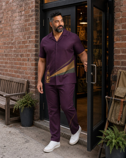 Big and tall man styling the Plum Gold Lantern Trail pocket-free shirt and matching pants set in a natural lifestyle scene