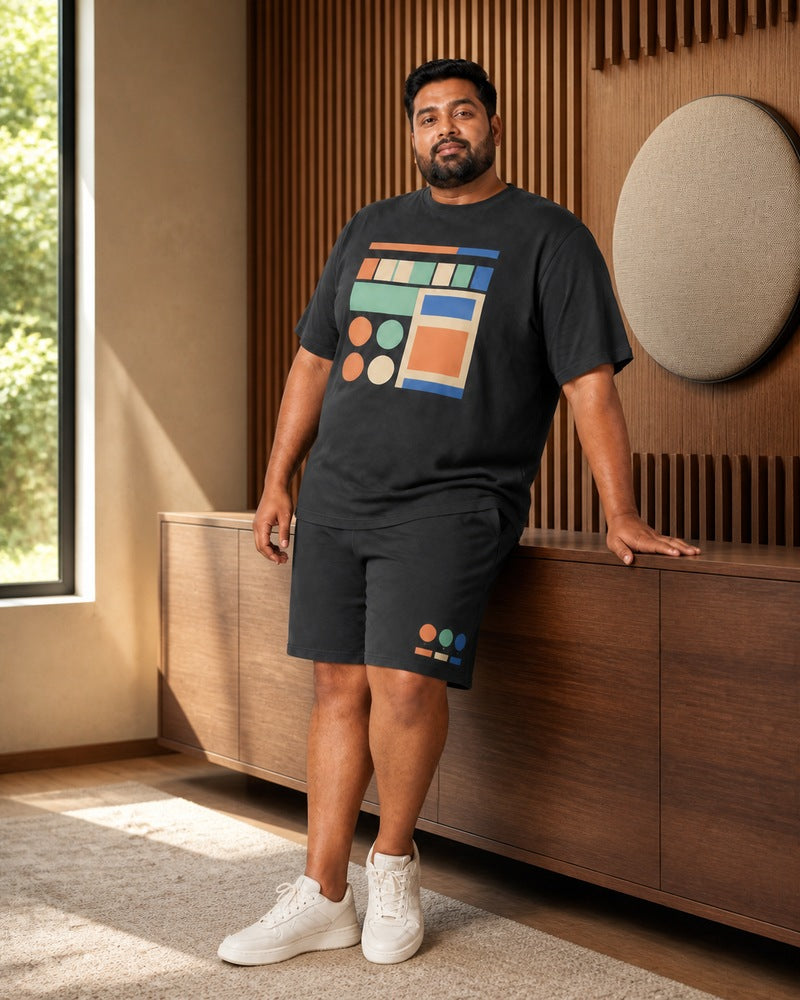 Big and tall man styling the Pocket Radio Parade t-shirt and matching shorts set in a natural lifestyle scene