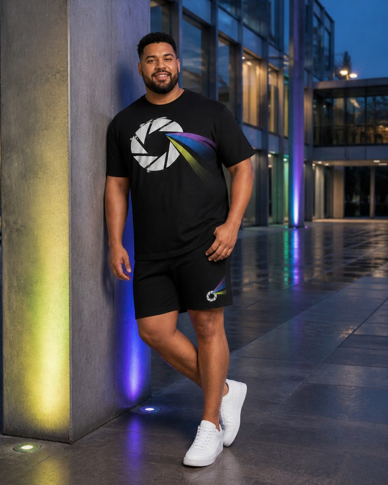 Big and tall man styling the Prism Aperture Pulse t-shirt and matching shorts set in a natural lifestyle scene