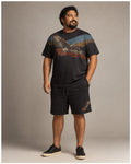 Big and tall man wearing the Redtail Horizon t-shirt and matching shorts set, clean full-body studio view