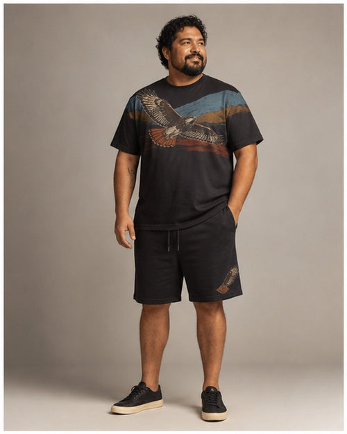 Big and tall man wearing the Redtail Horizon t-shirt and matching shorts set, clean full-body studio view