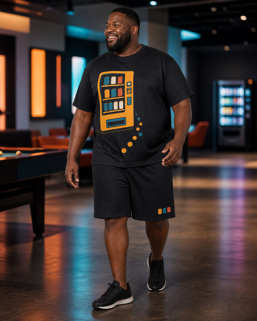 Big and tall man styling the Saffron Vending Glow t-shirt and matching shorts set in a lifestyle scene
