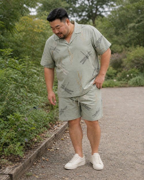 Big and tall man styling the Sage Dragonfly Meadow pocket-free shirt and matching shorts set in a lifestyle scene
