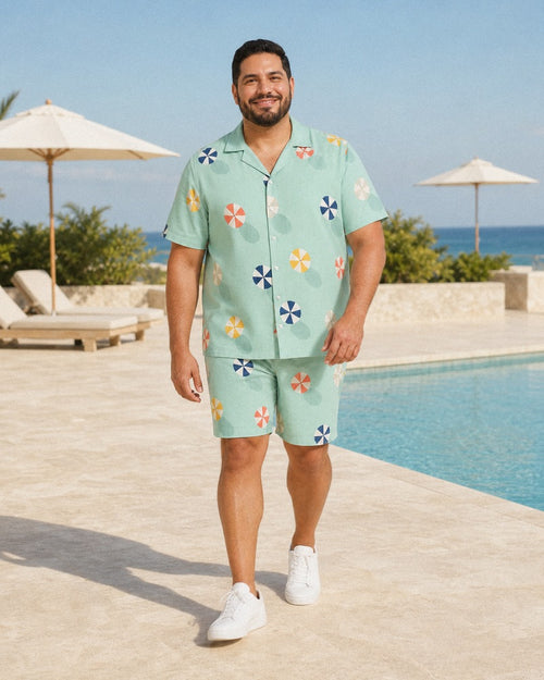 Big and tall man styling the Seafoam Parasol Scatter pocket-free shirt and matching shorts set in a natural lifestyle scene