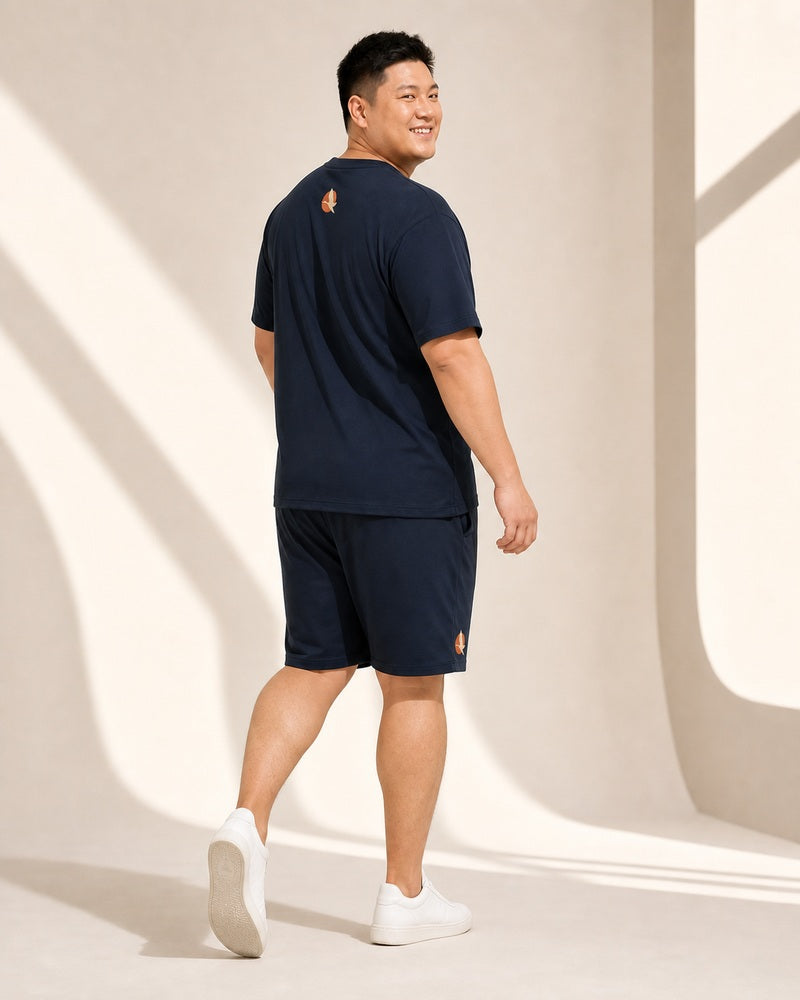 Big and tall man walking in the Solar Heron Archive set, rear three-quarter fit view