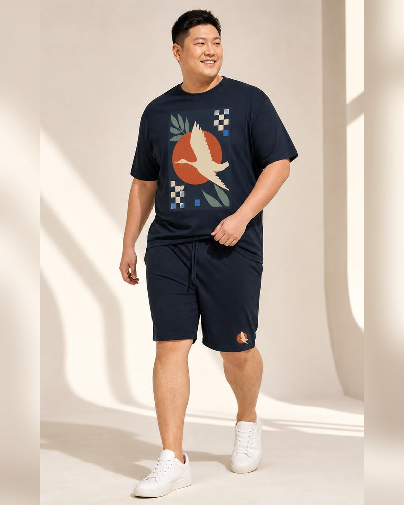 Big and tall man walking in the Solar Heron Archive T-shirt and matching shorts set, full-body studio view
