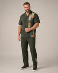Big and tall man wearing the Solstice Patchwork pocket-free shirt and matching pants set, clean full-body studio view