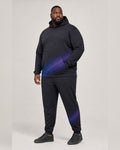 Big and tall man wearing the Violet Nightwave hoodie and matching pants set, full-body front three-quarter studio view